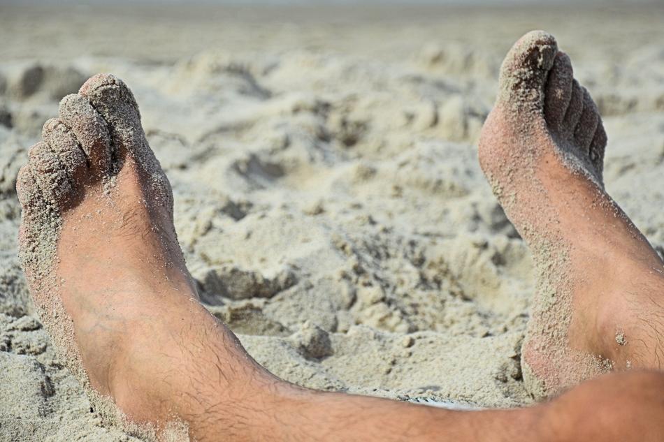 Feet on sand Beach closeup photo