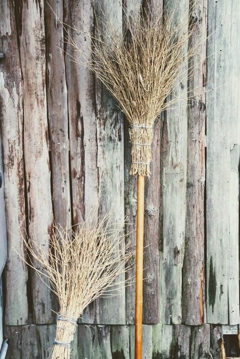 hand broom on a wooden wall