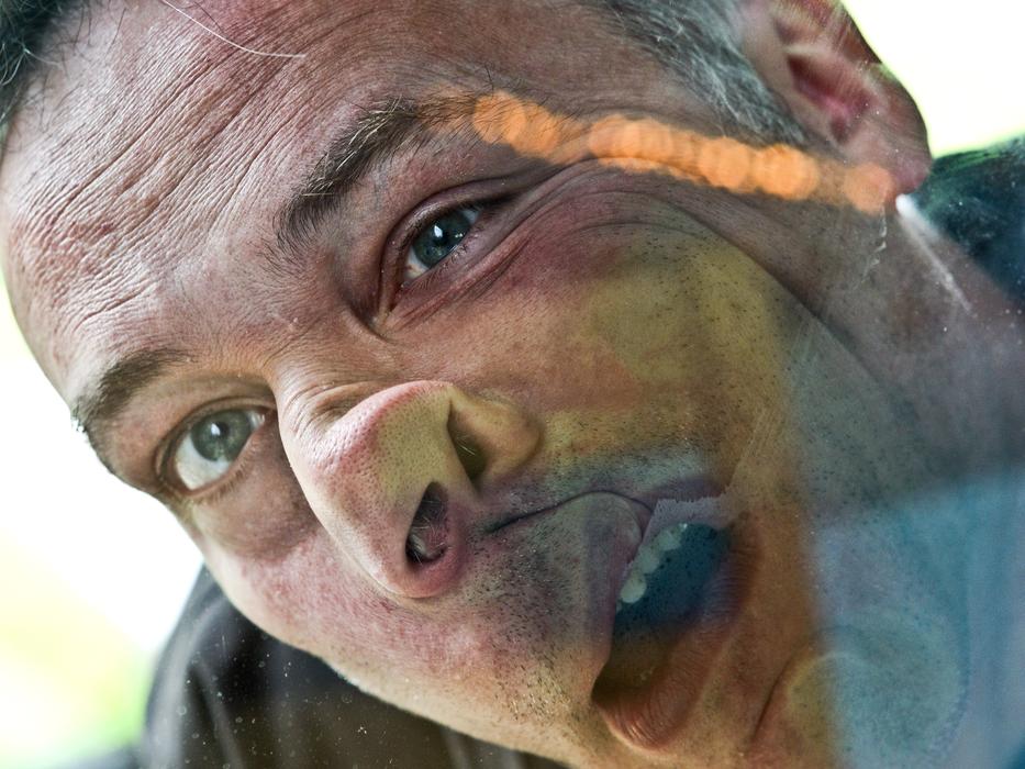 grimace of a man through the glass