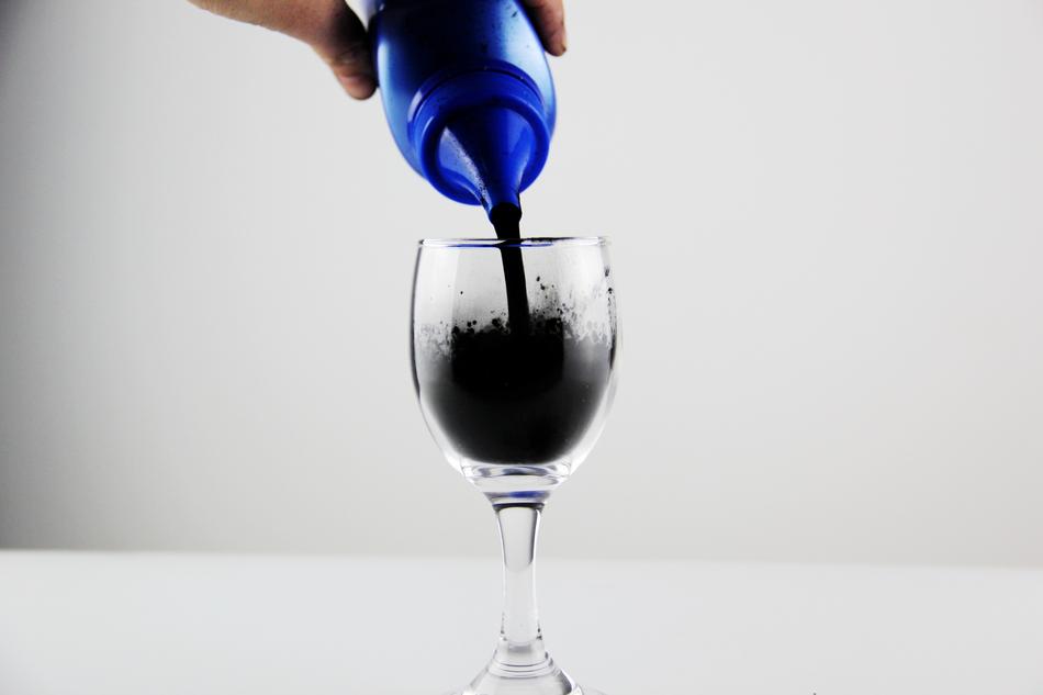 pigmented black paint in a cup