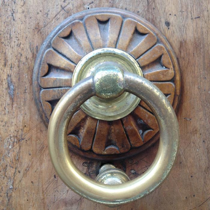 gold handle on a wooden door