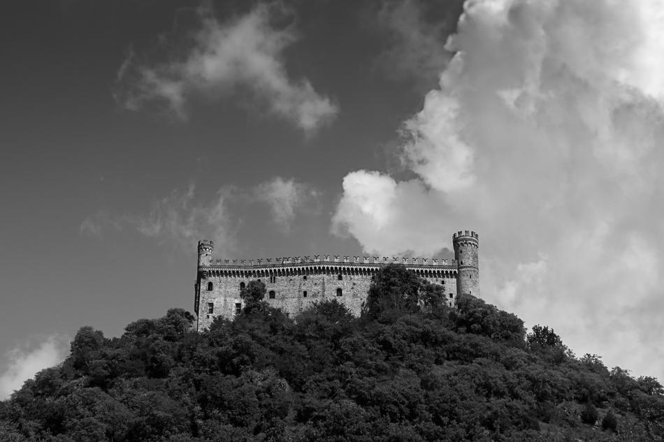 an old castle on a hill of trees