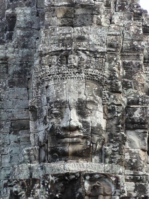 a man's face on a stone wall