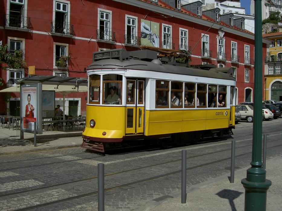 a beautiful streetcar with a yellow carriage