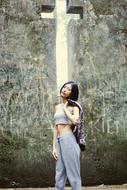 Asian model in the background of a hole in the form of a cross