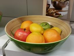 ripe fruit in a green bowl