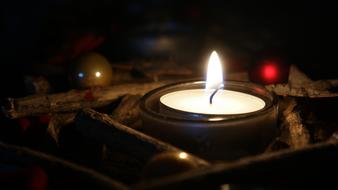 burning candle on the table in the room
