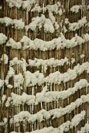 Snow on straw fence