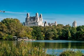 Beautiful building, among the colorful plants, on the shore, in Manhattan, New York, USA