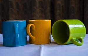 colored mugs on the table