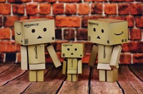Beautiful family of Danbo on the wooden surface near the brick wall