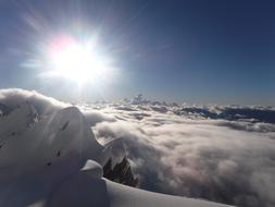 bright sun over the snowy mountains