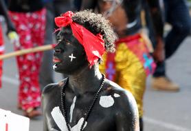 young dark skin man with makeup on carnival, dominican republic