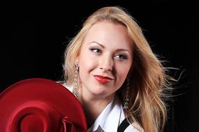 beautiful young Girl holding red Hat