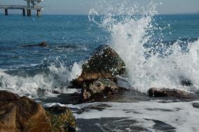 sea waves crash on the rocks