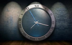 large image of a clock on a background of blue brick wall
