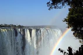 Rainbow rays against a waterfall