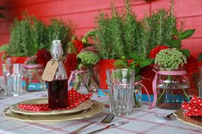 bottle of drink on a table with flowers