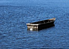 an old boat in the blue sea