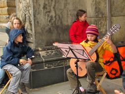 Kids with Music stand and instruments on street
