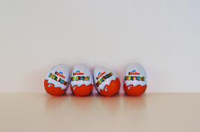 Beautiful red and white Kinder Surprises with colorful text