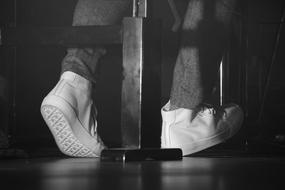 feet press the piano pedal black and white