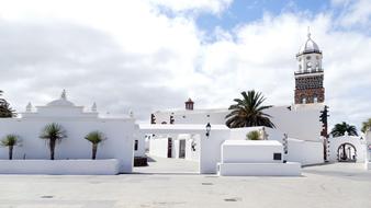 tower behind white buildings