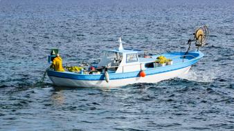 a boat floating in the sea on the waves