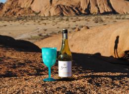 blue glass with a bottle of wine