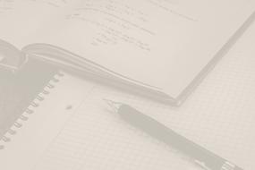 a pen on a notebook in faded colors