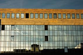 buildings are reflected in the mirrored facade