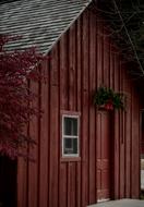 Beautiful , brown house with red and green Christmas decorations