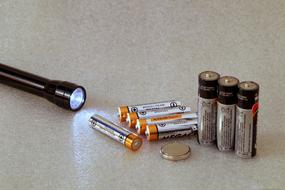 batteries and a flashlight are on the table