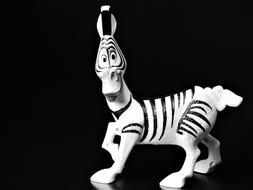 cartoon zebra figurine on a black background