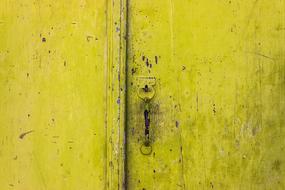 yellow wooden door of a building in Greece