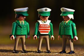 police figurine in a green suit