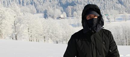 guy in black among a sunny snowy landscape