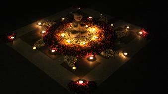 candles among the stones near the mandala