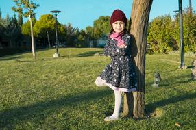 Kid posing on the grass near the tree in Kurdistan