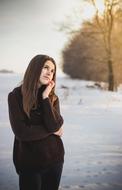 photo of a pensive girl on a winter field