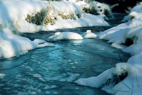 river in the snow stones