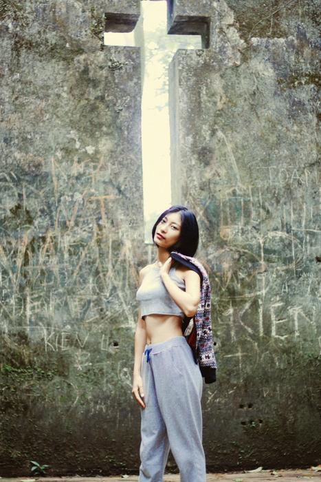 Asian model in the background of a hole in the form of a cross