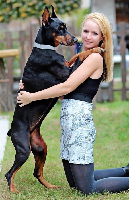 a girl with a doberman