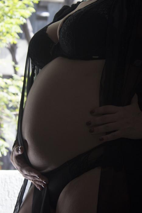 a girl in lingerie with a belly