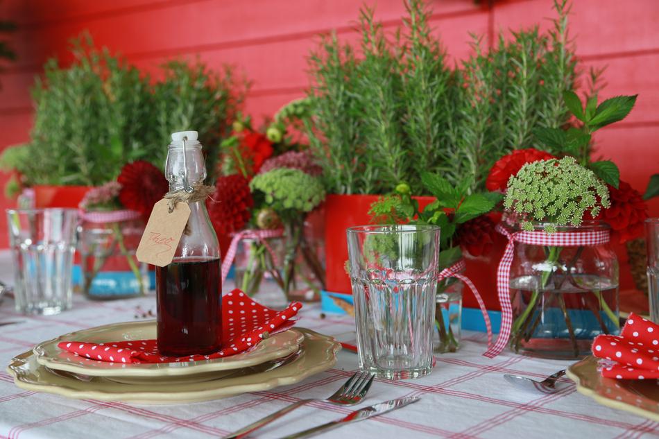 bottle of drink on a table with flowers