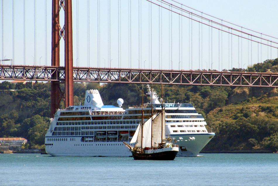 ship sailing under the bridge