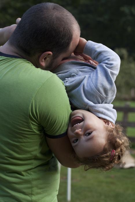 A happy child in his father's arms
