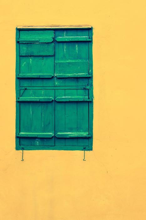 green shutters on a window of a building in Paralimni, Cyprus