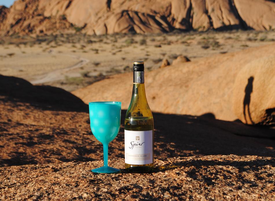 blue glass with a bottle of wine