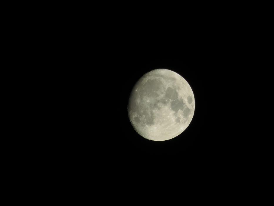 white moon in a dark sky